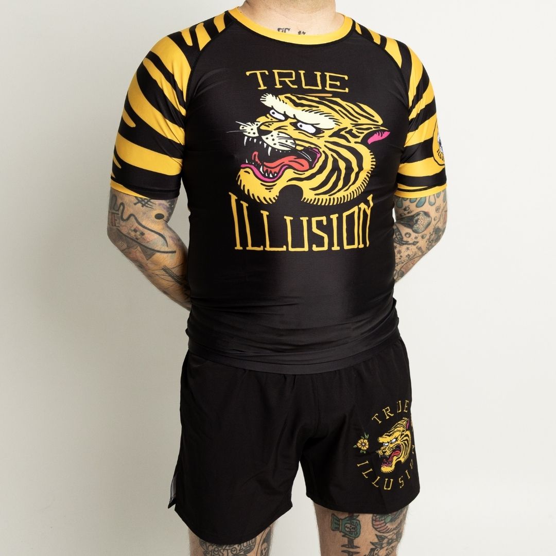 Wearing True Illusion Tiger BJJ rashguard and shorts set front view