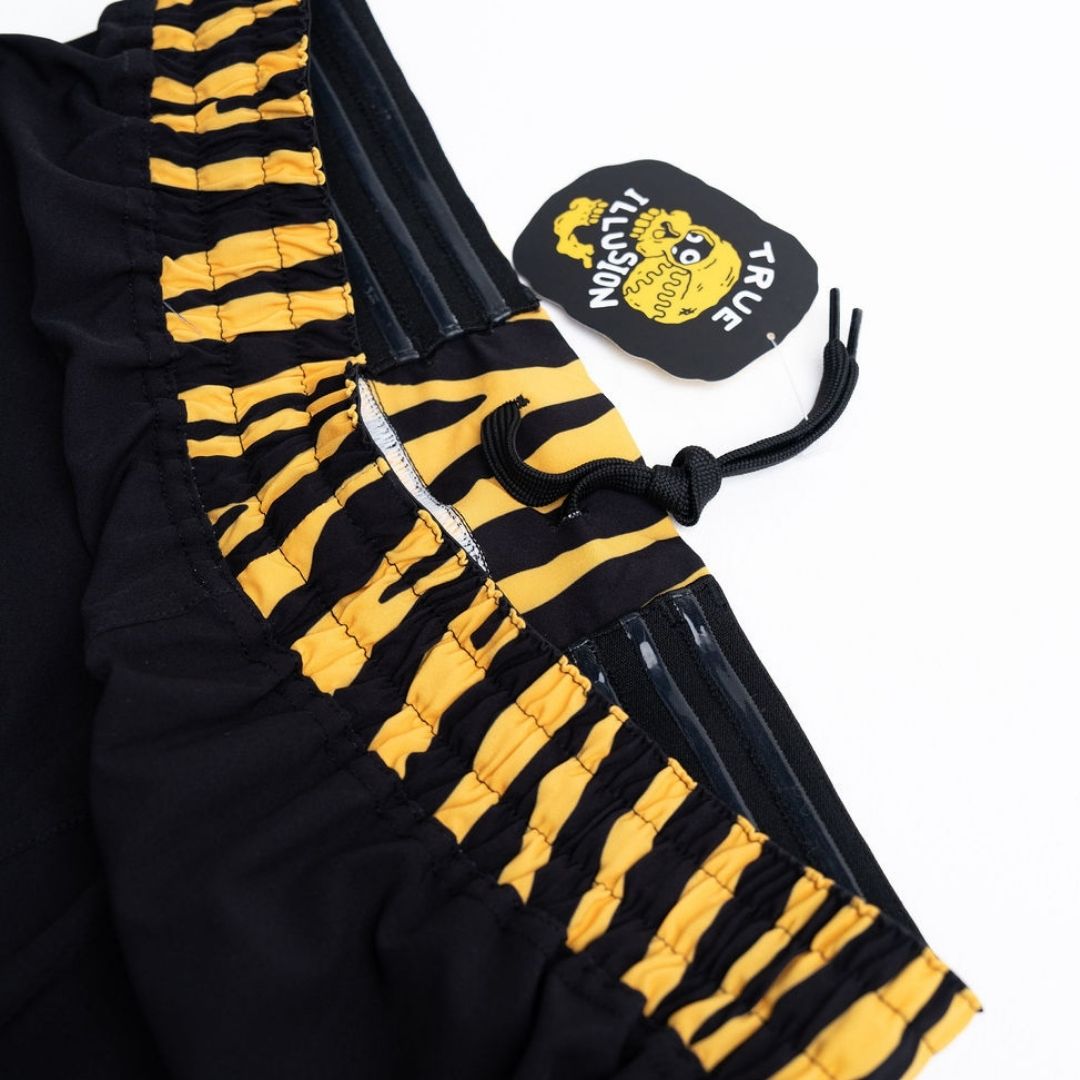 True Illusion BJJ Shorts - Tiger, close-up of ruched tiger-stripe side panels, drawstring, and brand hangtag