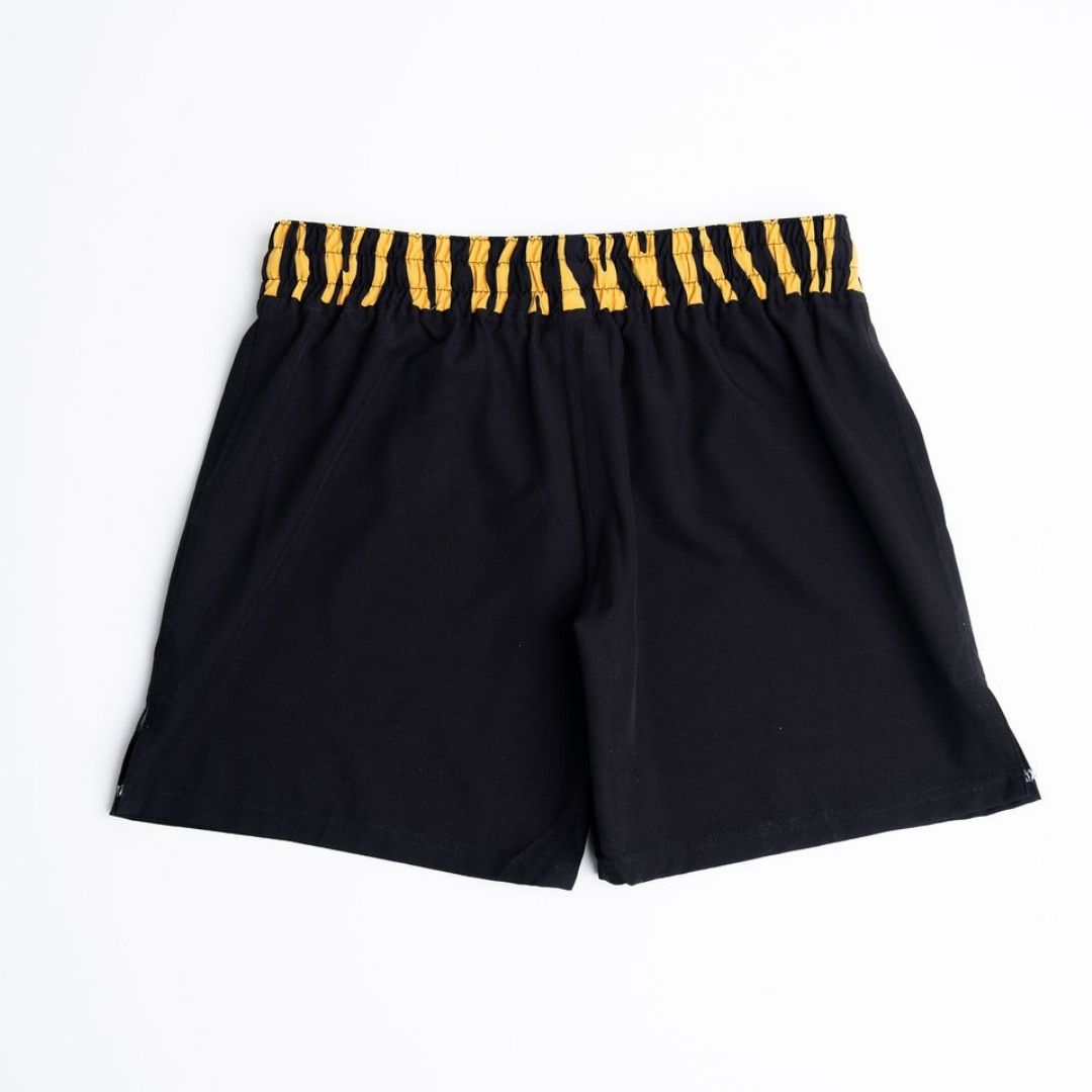 True Illusion BJJ Shorts Tiger, front flat lay showing black shorts with gold tiger-print elastic waistband