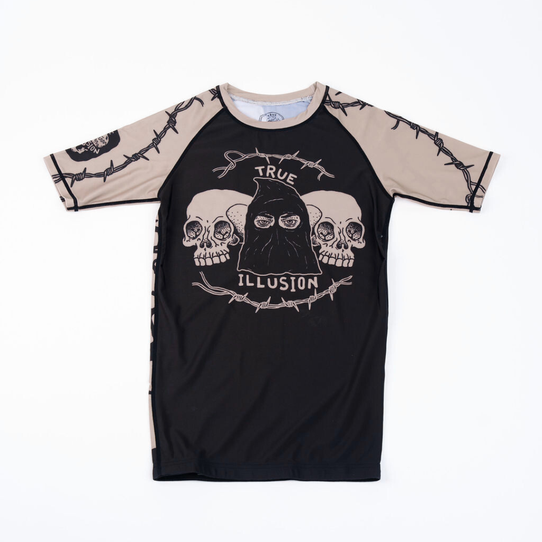 True Illusion Executioner Short Sleeve BJJ Rash Guard, front flat lay, black body with tan raglan sleeves featuring barbed