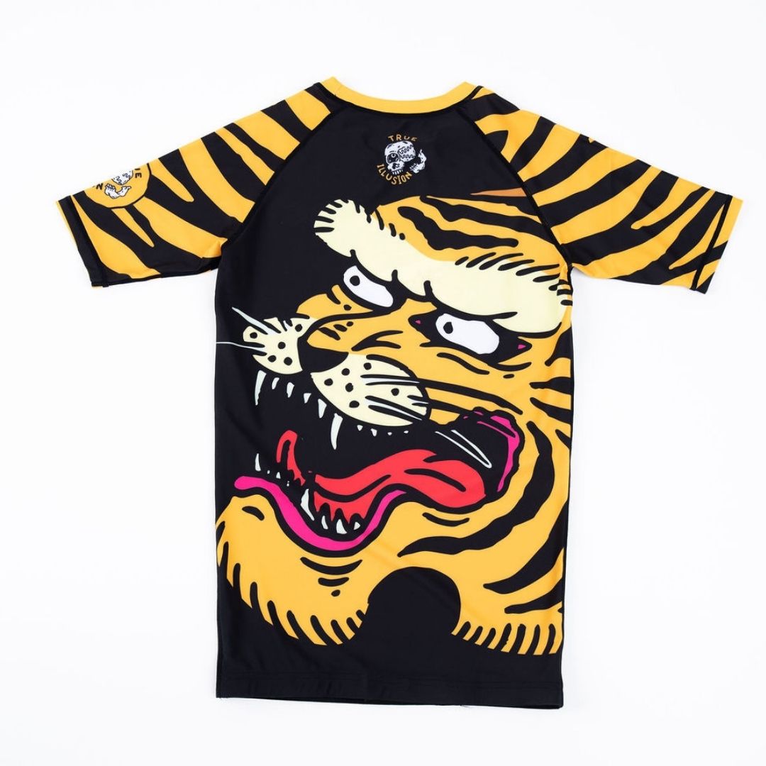 True Illusion Short Sleeve BJJ Rash Guard - Tiger, back flat lay showing large roaring tiger graphic with gold and black