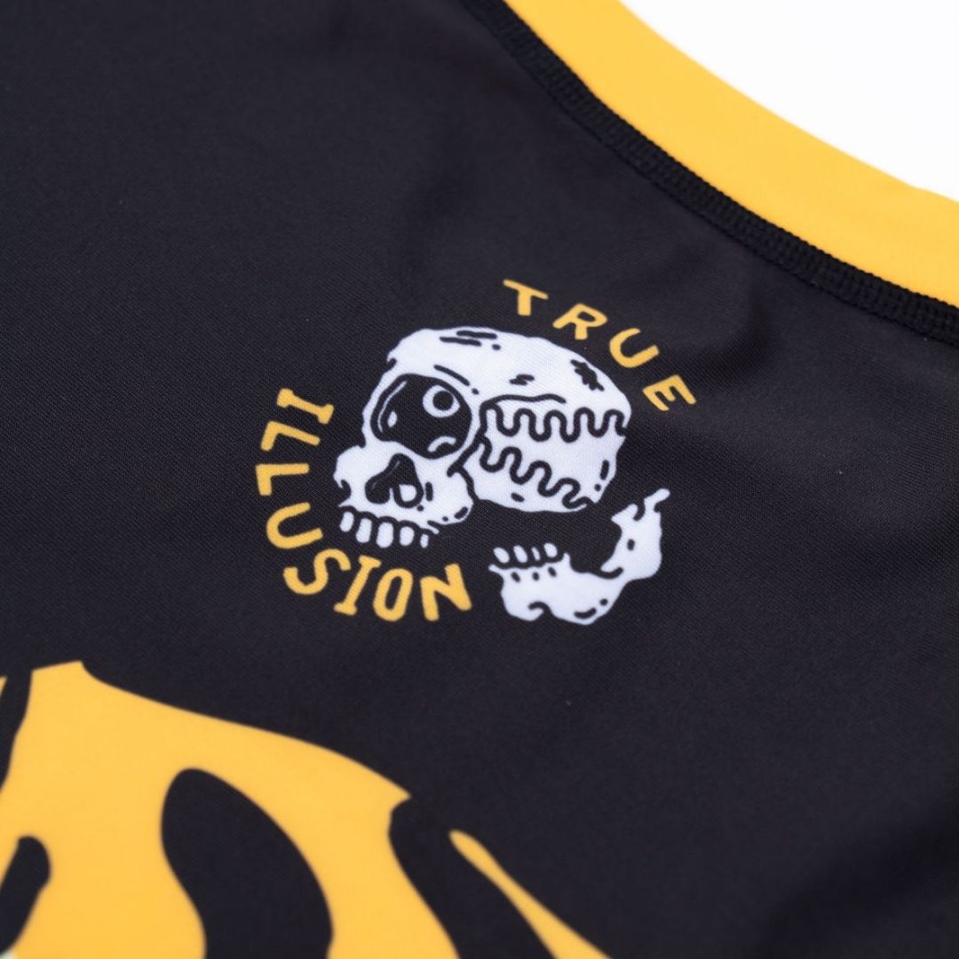 True Illusion Tiger Short Sleeve BJJ Rash Guard, close-up of chest skull graphic and yellow neckline trim on black fabric